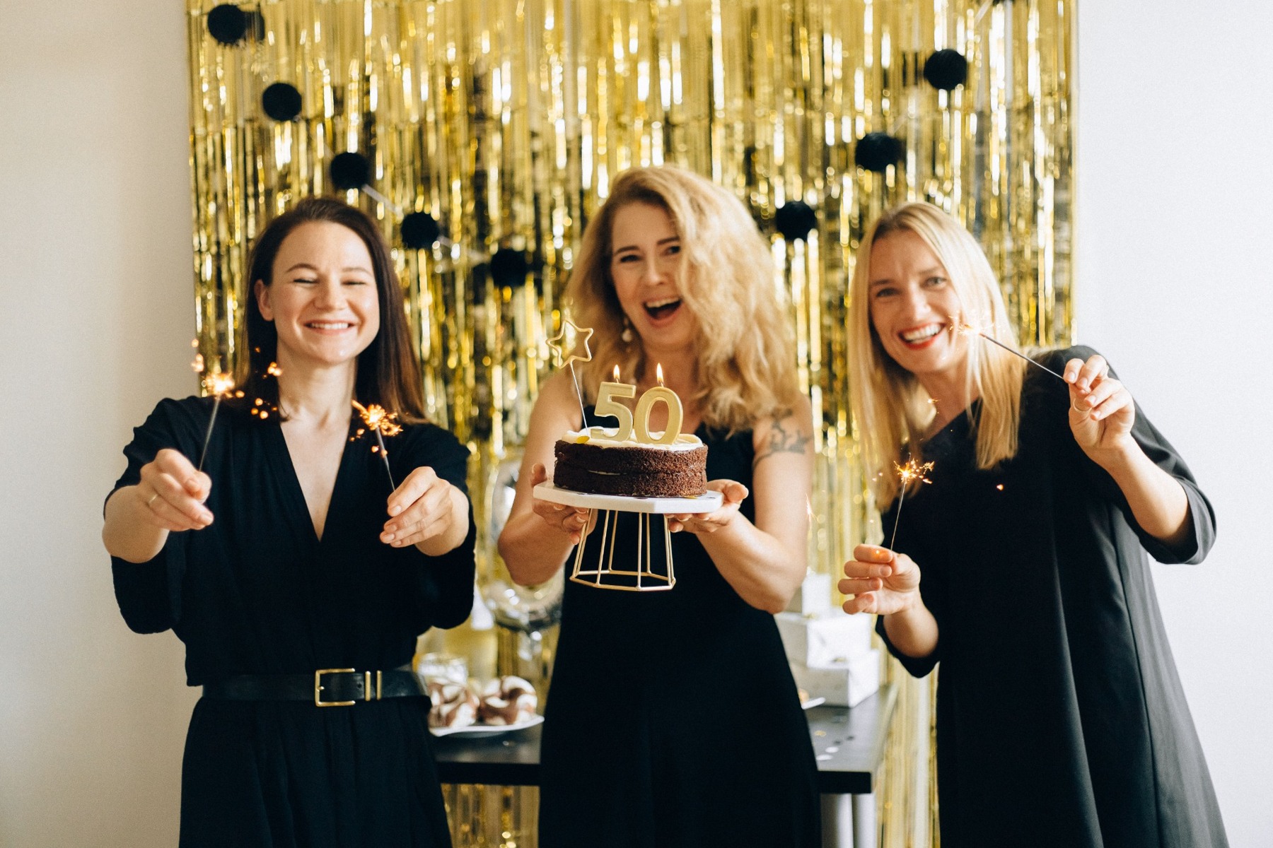 Three women celebrating a fiftieth birthday together