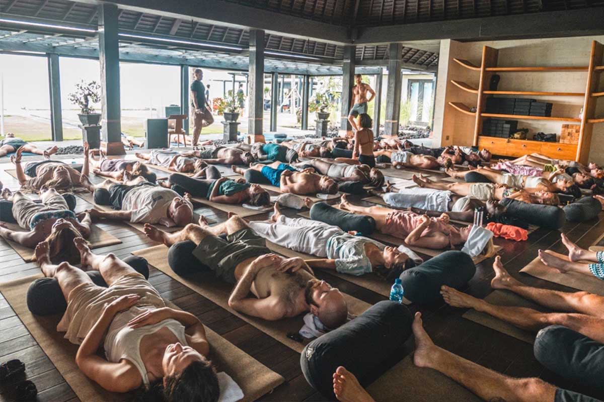 Adults resting on mats during a group breathwork session