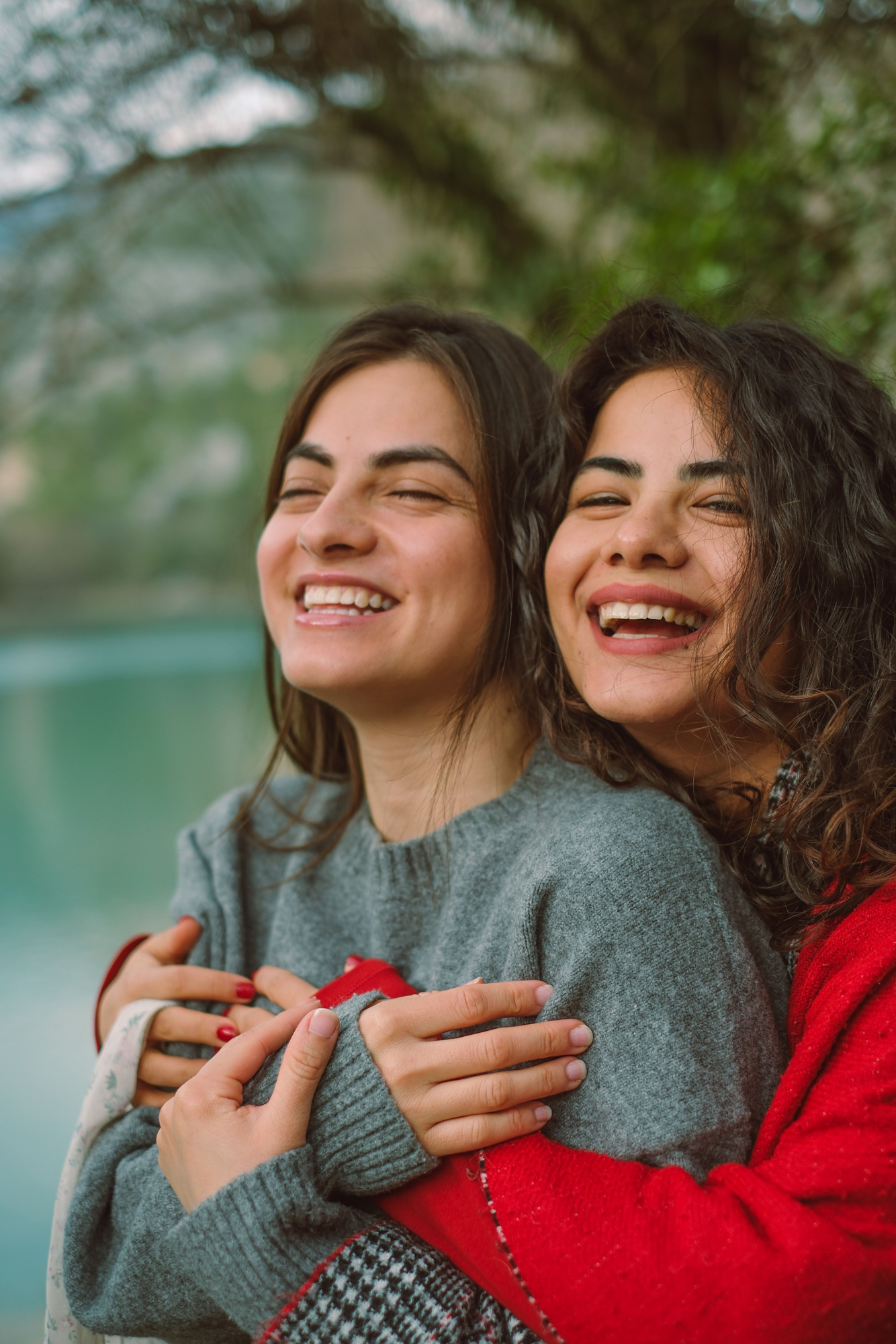 Two women sharing an embrace outdoors